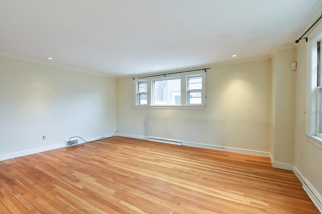 empty room featuring light wood-style floors, baseboards, and ornamental molding