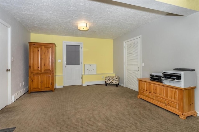 interior space featuring a textured ceiling, a baseboard radiator, carpet flooring, and baseboards