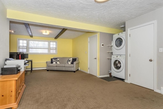 washroom with a textured ceiling, laundry area, carpet flooring, and stacked washer / drying machine