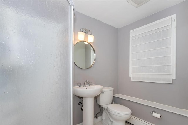 bathroom with a baseboard radiator, visible vents, and toilet