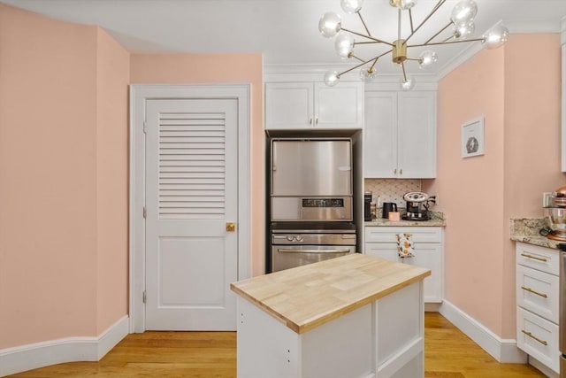 17 Gloucester St Unit A, Boston, MA 02115 - kitchen with wooden counters, light wood finished floors, white cabinetry, and decorative backsplash