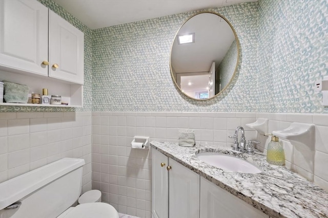 17 Gloucester St Unit A, Boston, MA 02115 - bathroom with wallpapered walls, tile walls, vanity, and a wainscoted wall