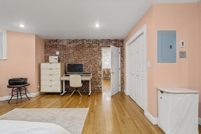 17 Gloucester St Unit A, Boston, MA 02115 - home office featuring electric panel, light wood-style flooring, brick wall, and recessed lighting