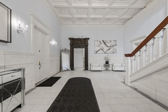 17 Gloucester St Unit A, Boston, MA 02115 - entrance foyer featuring coffered ceiling, ornamental molding, a wainscoted wall, light tile patterned flooring, and a towering ceiling