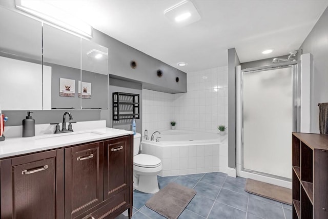 bathroom with vanity, a bath, a stall shower, tile patterned floors, and toilet