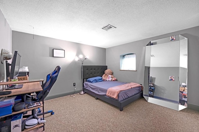 bedroom featuring visible vents, carpet floors, and a textured ceiling