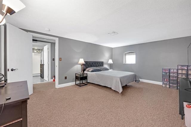 carpeted bedroom with visible vents, baseboards, a textured ceiling, and baseboard heating