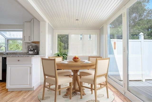 dining space featuring wooden ceiling, crown molding, sink, and light hardwood / wood-style flooring