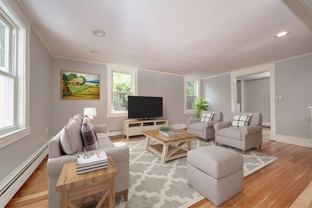 living room with light hardwood / wood-style floors, ornamental molding, and baseboard heating