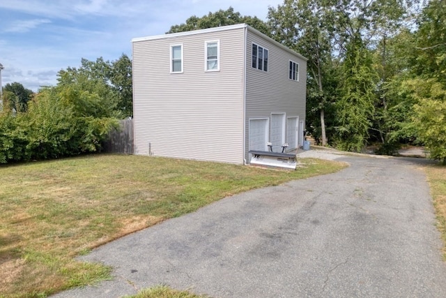 view of side of property with a yard