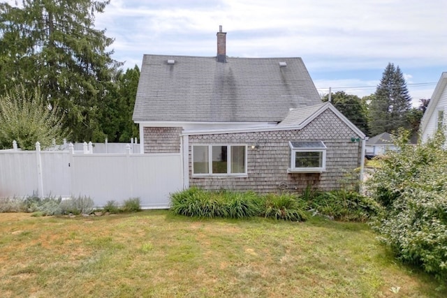 rear view of house with a lawn