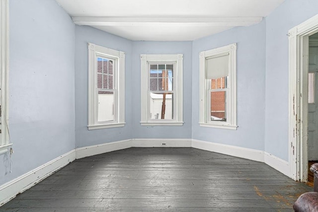 spare room with dark wood-style floors and baseboards