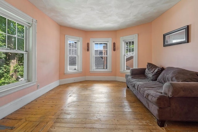 living room featuring light wood-type flooring and baseboards