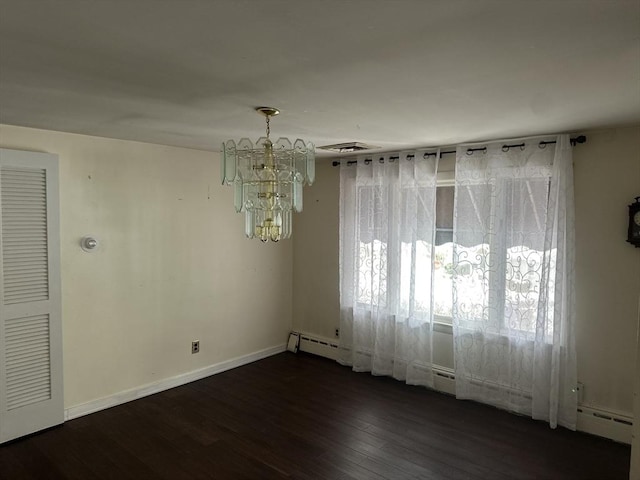 unfurnished dining area with dark wood-style flooring, visible vents, an inviting chandelier, a baseboard heating unit, and baseboards