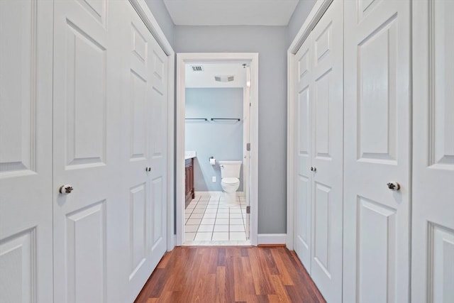 corridor featuring dark wood-type flooring