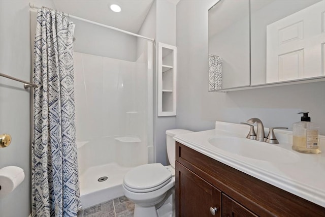 bathroom featuring vanity, curtained shower, and toilet