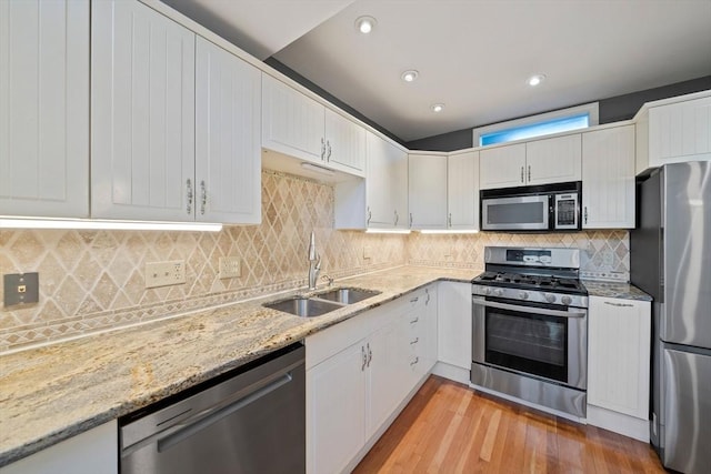 kitchen featuring white cabinetry, stainless steel appliances, and sink