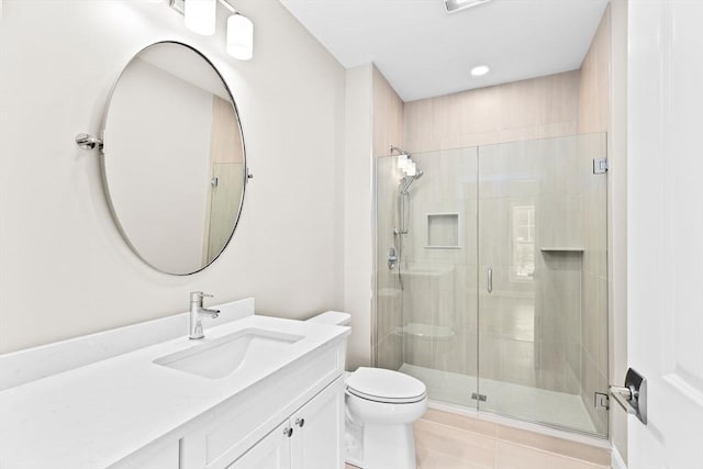 bathroom featuring toilet, tile patterned floors, a shower stall, and vanity