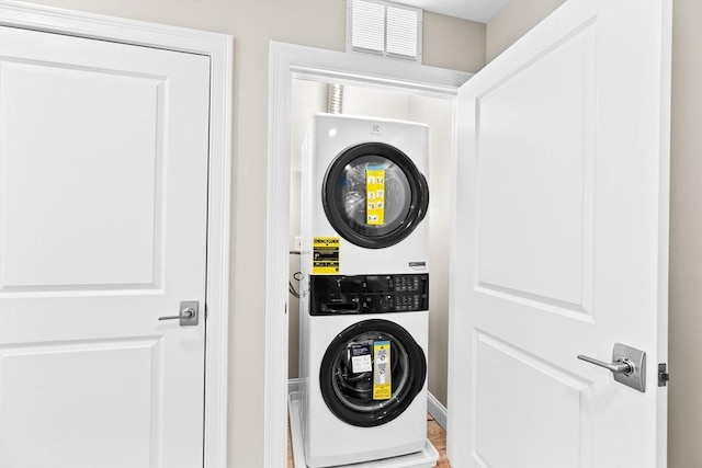 washroom featuring laundry area, visible vents, and stacked washer / dryer