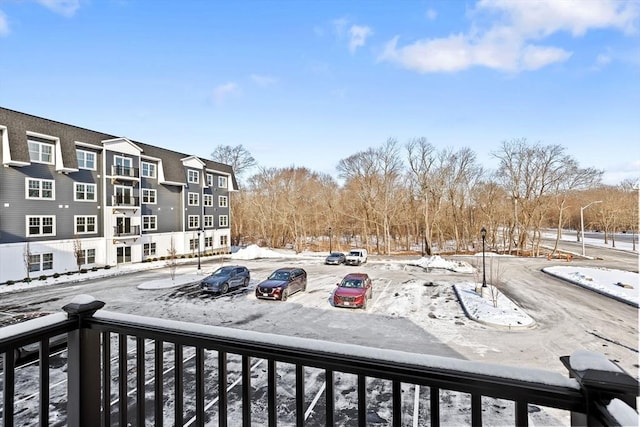 view of snow covered back of property