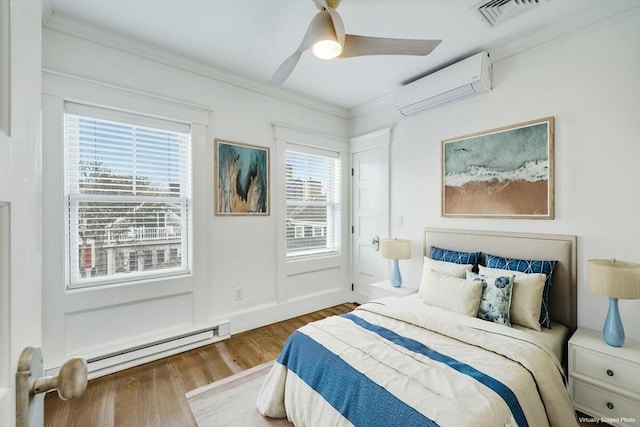 bedroom featuring ceiling fan, baseboard heating, an AC wall unit, hardwood / wood-style flooring, and ornamental molding