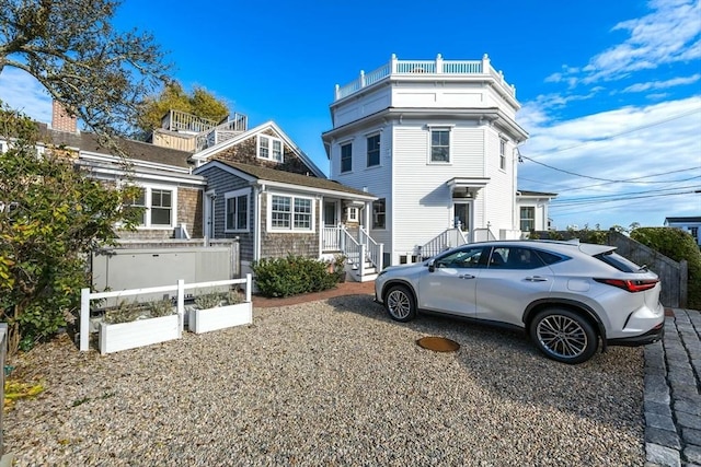 view of side of home featuring a balcony