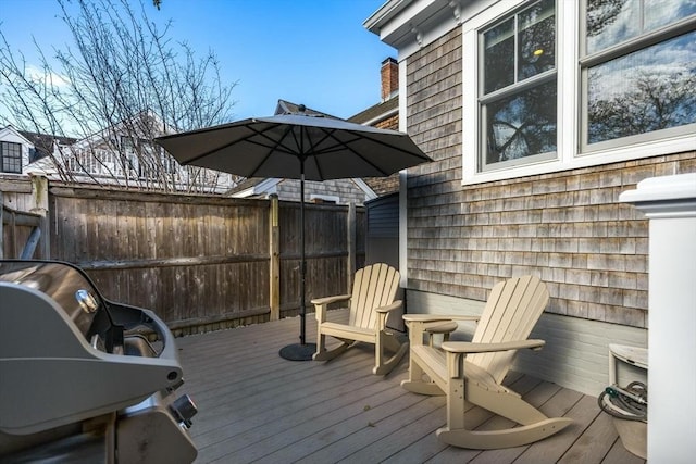 wooden terrace with a grill