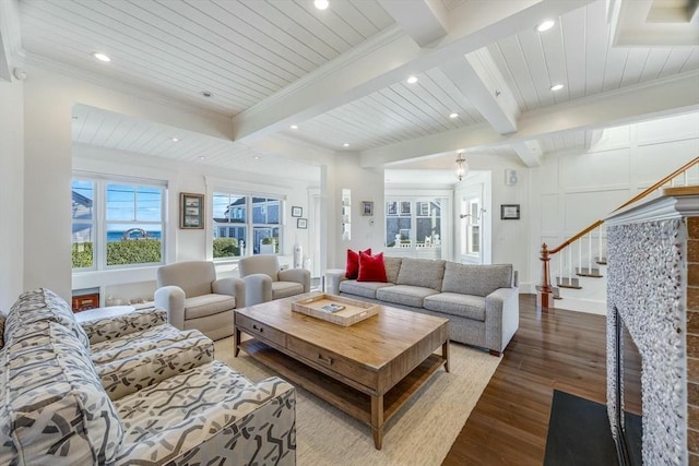 living room with beamed ceiling, light hardwood / wood-style flooring, crown molding, and wood ceiling