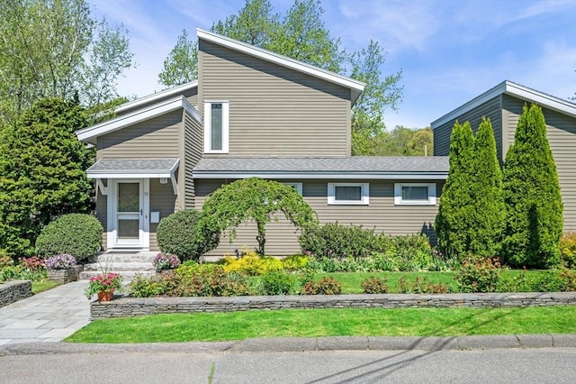 view of home's exterior featuring roof with shingles