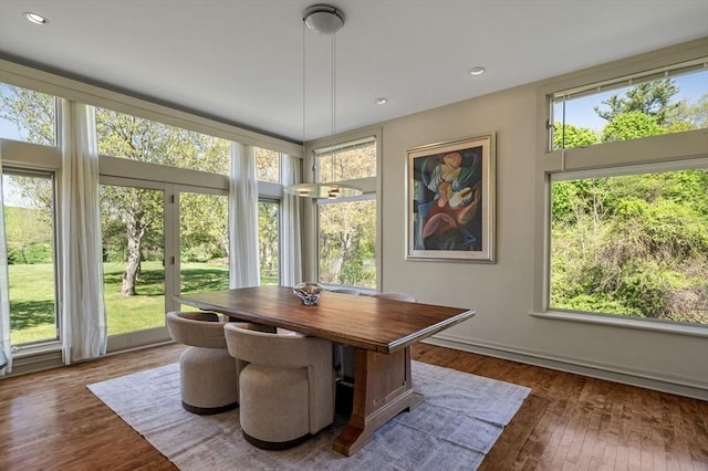 dining space with wood finished floors, recessed lighting, and baseboards
