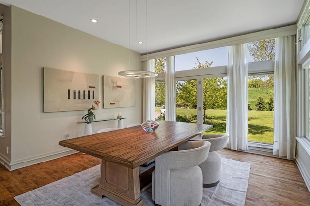 dining room with wood finished floors, recessed lighting, and baseboards