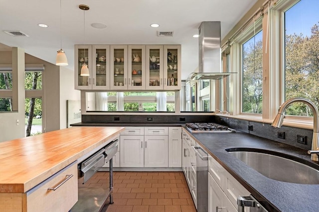 kitchen featuring a sink, wooden counters, island exhaust hood, stainless steel appliances, and recessed lighting