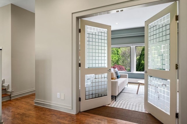 doorway featuring wood finished floors, baseboards, and recessed lighting