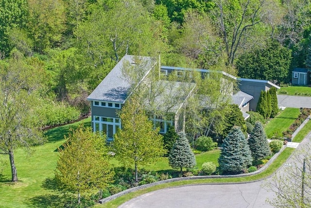 view from above of property featuring a heavily wooded area