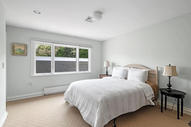 bedroom with radiator heating unit, multiple windows, and baseboards