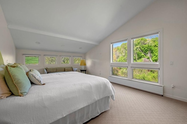 bedroom with vaulted ceiling, light colored carpet, baseboards, and a baseboard heating unit