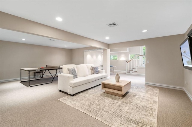 living area featuring light carpet, recessed lighting, and baseboards