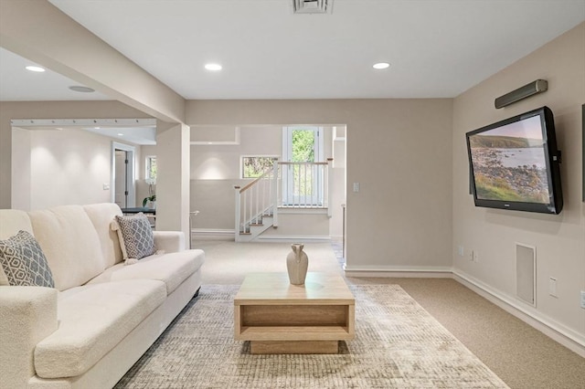 carpeted living area with baseboards, recessed lighting, and stairway