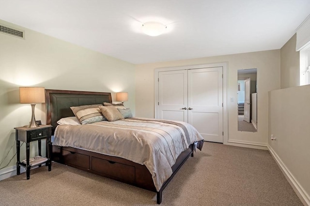 bedroom featuring light carpet, a closet, and baseboards