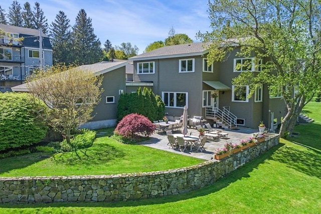 rear view of house featuring a patio and a yard