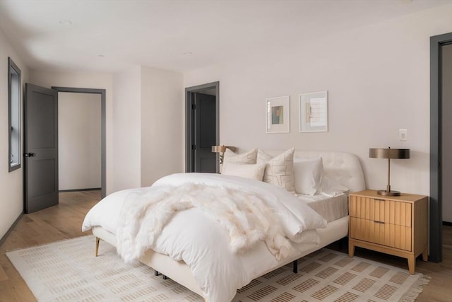 bedroom with light hardwood / wood-style floors