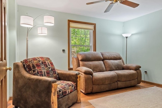living area with light wood-style flooring and ceiling fan