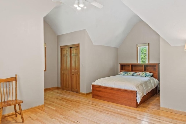 bedroom featuring light wood-style floors, vaulted ceiling, ceiling fan, and baseboards
