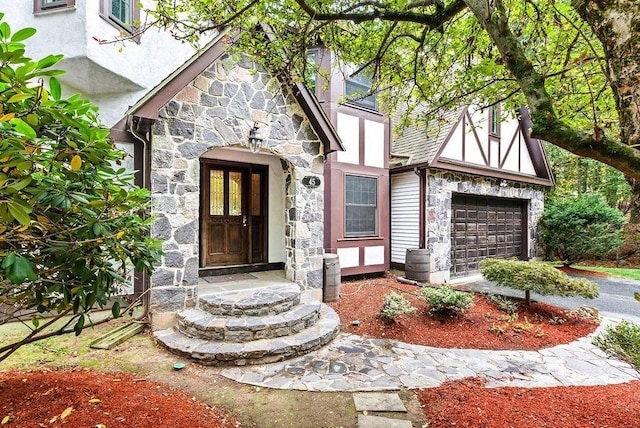 property entrance with stone siding, a garage, stucco siding, and cooling unit