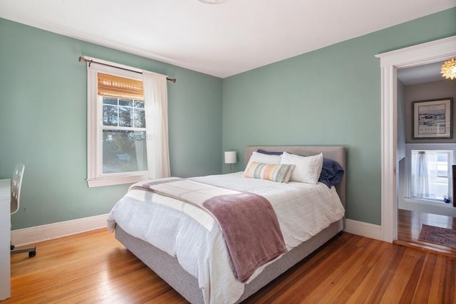 bedroom with baseboards and hardwood / wood-style floors