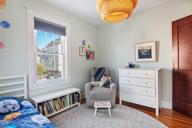 bedroom with wood finished floors and baseboards