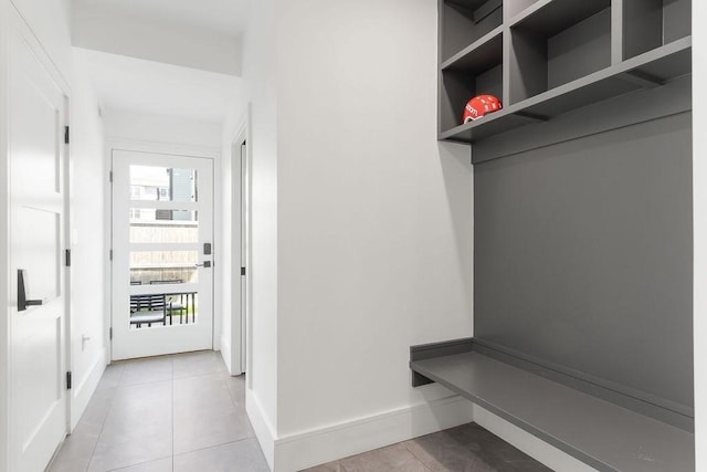 mudroom with baseboards and light tile patterned floors
