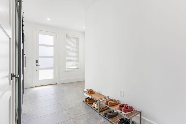 entryway with recessed lighting and light tile patterned flooring