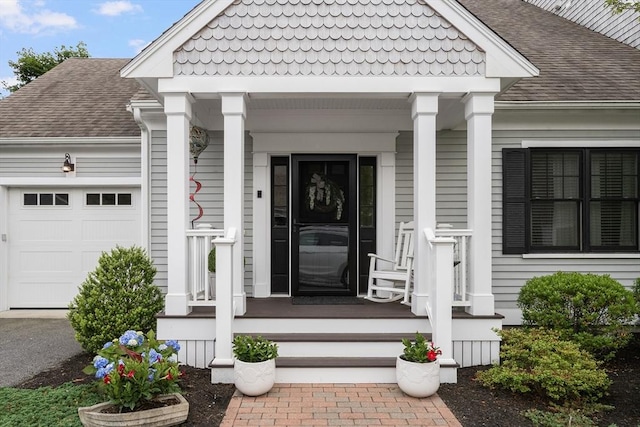 675 Main St Unit C1, Barnstable, MA 02635 - view of exterior entry with a garage, a porch, and roof with shingles