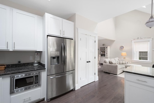 675 Main St Unit C1, Barnstable, MA 02635 - kitchen with stainless steel appliances, dark wood finished floors, lofted ceiling, white cabinetry, and dark stone counters